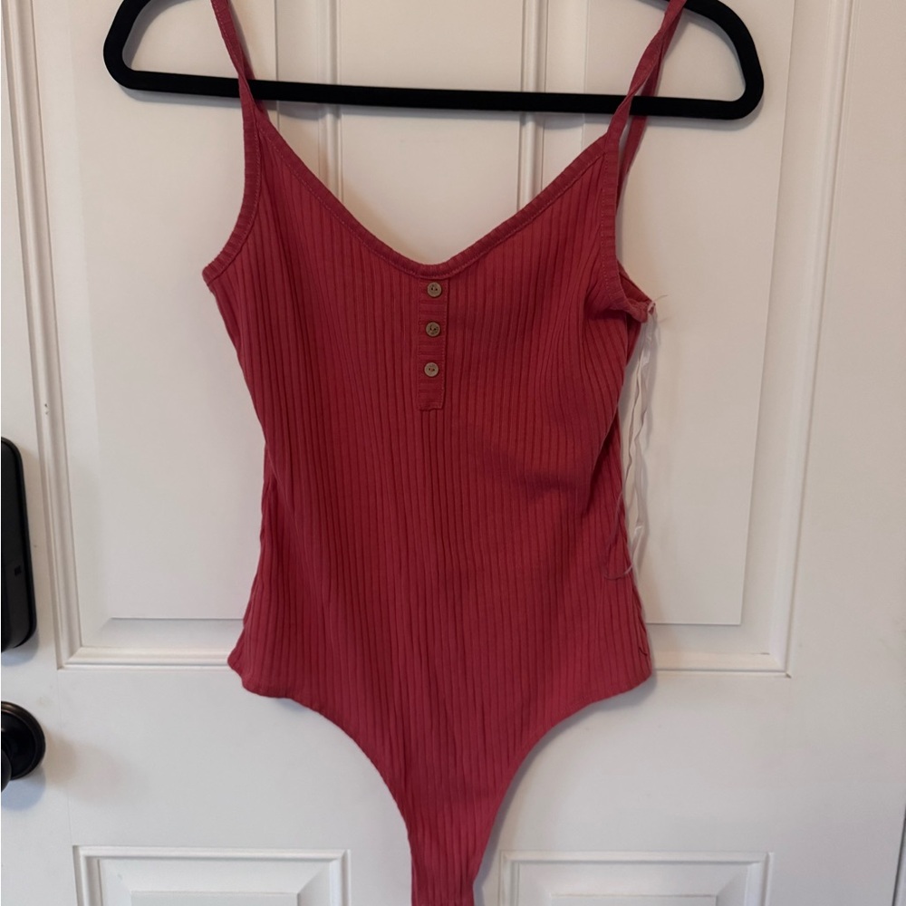 2 pink bodysuits